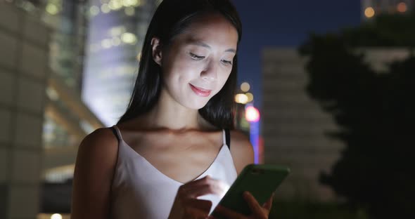 Woman use of smart phone at night 