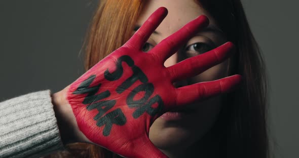 Girl Rebels Against the System and Refuses War By Painting Her Hand Red