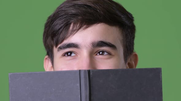 Young Handsome Iranian Teenage Boy Against Green Background