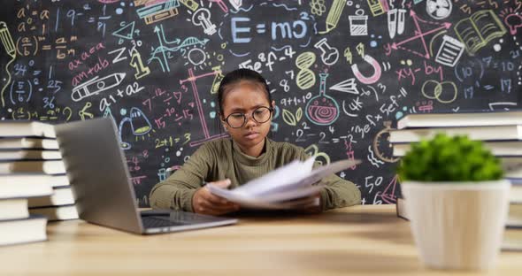 Kid girl student preparing for exams with headset