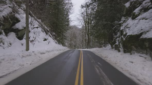 Scenic Road in the Canadian Nature Forest with Snow During Winter