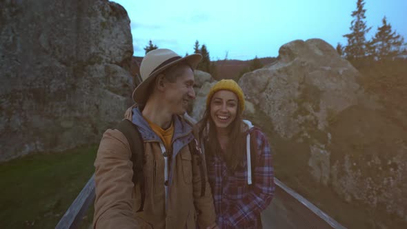 Happy Smiling Couple Hiker Walks Together in National Park Tustan in Ukraine