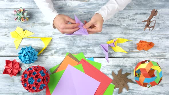 Hands Folding Origami Cranes, Fast Motion.