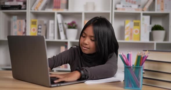 Happy girl learning online via laptop