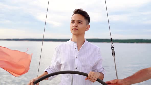 Young Captain at the Helm of the Sailboat