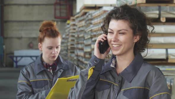 Beautiful Happy Female Factory Worker Talking on the Phone