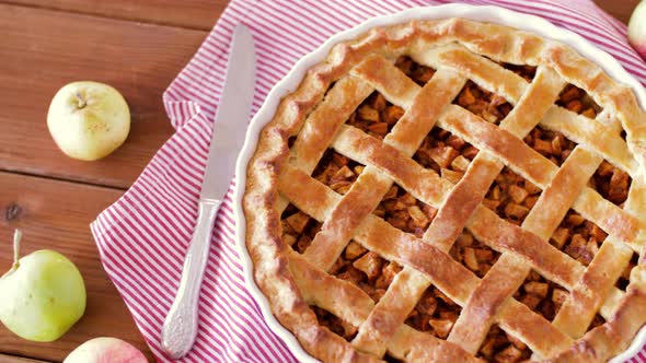 Close Up of Apple Pie and Knife on Wooden Table