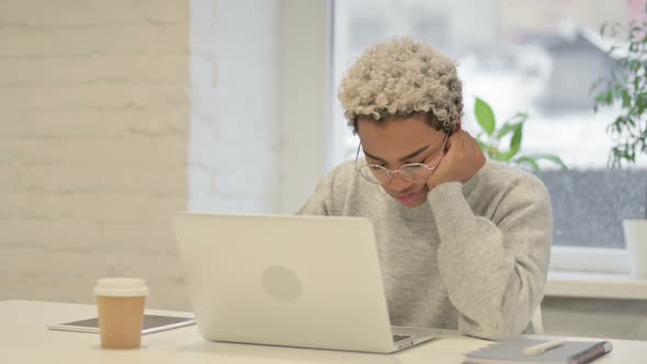 Tired African Woman Taking Nap While Sitting in Office with Laptop