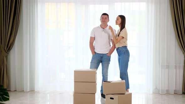 Couple Wearing Jeans Plans Furniture Location in New House