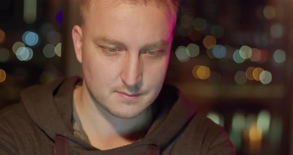 The face of a young man working on a computer