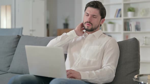 Hardworking Man with Laptop Having Neck Pain at Home