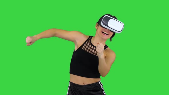 Happy Smiling Young Girl Using VR Headset Glasses Playing Dancing Game First Time on a Green Screen