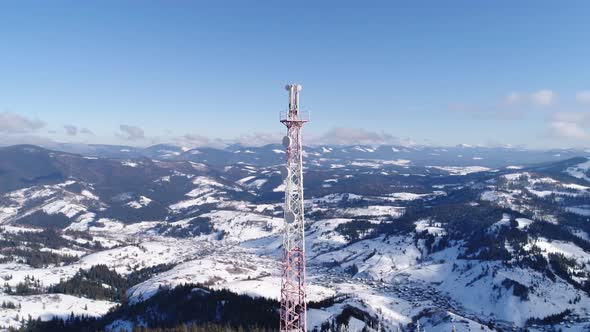 Flying Over Radio Communications Tower, Mountain Snow Covered Winter Landscape