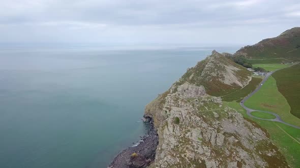 Aerial tracking forward over the Valley of Rocks and Wringcliff Bay in Devon. Stunning rocky crags a