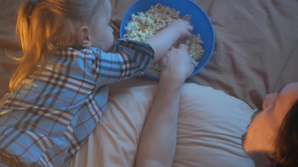 Happy Family Dad and Daughter Watch TV Eat Popcorn Love Each Other