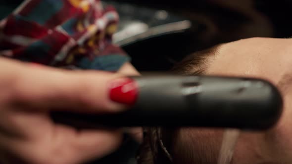 Barbershop: female barber washes the head of male client