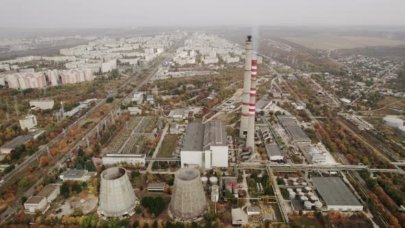 Aerial View of the High Pipes of the Thermal Power Plant Near the Modern City
