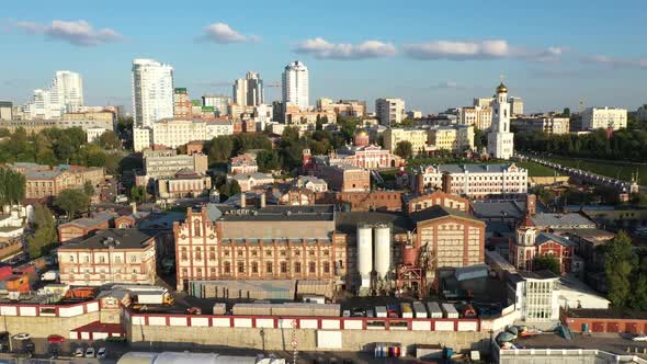 Quadrocopter Flies Over the Territory of the Plant in the City. Large Buildings of the City