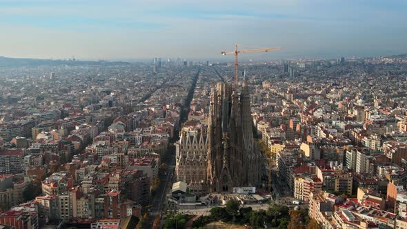 Aerial drone view of Barcelona, Spain. Blocks with multiple residential buildings and Sagrada Famili