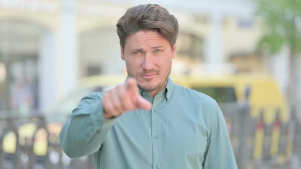 Outdoor Middle Aged Man Pointing at the Camera and Inviting