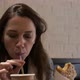 Young Woman Eating Delicious Baked Croissant and Drink Tea in Cafe - VideoHive Item for Sale