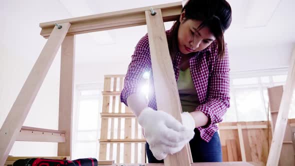 Woodwork and furniture making concept. Stylish craftswoman working in carpentry