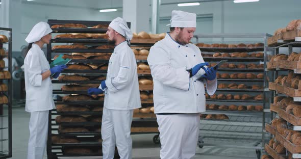 Group of Three Bakers in a Bakery Section in a