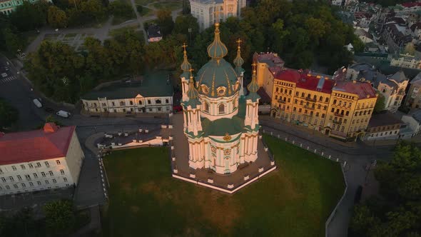 Beautiful Church with Blue and Gold Domes in Kyiv on Top of a Hill Sunset