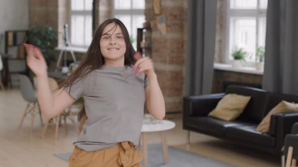 Happy Woman Dancing Energetically at Home