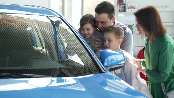 Mother Father and Child Buying Car at Dealership a New Family Auto