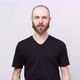 Portrait of calm bearded man looking at camera isolated over white background - VideoHive Item for Sale