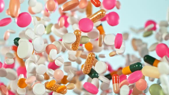 Super Slow Motion Shot of Flying Colorful Pills on Gradient Background at 1000Fps