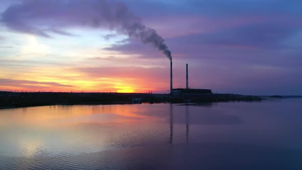 Chemical plant over the river at sunset. 