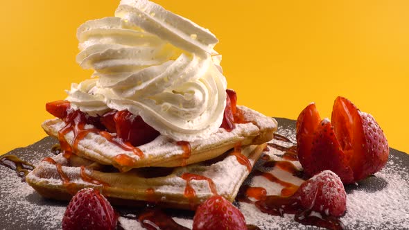 Belgian waffles with strawberry, sweet strawberry topping, whipped cream and powdered sugar