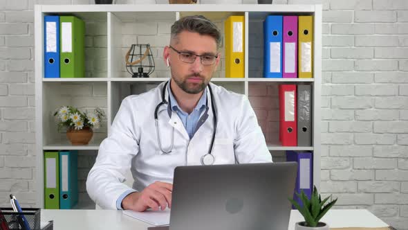 Remote doctor in medical coat listen patient online video call laptop webcam