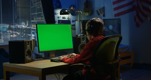 Boy Using His Computer at Night