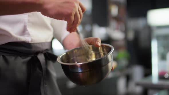 Chef Blending Ingredients with Whisk