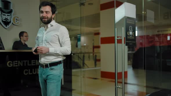 Bearded Man Customer Coming Into a Modern Barbershop