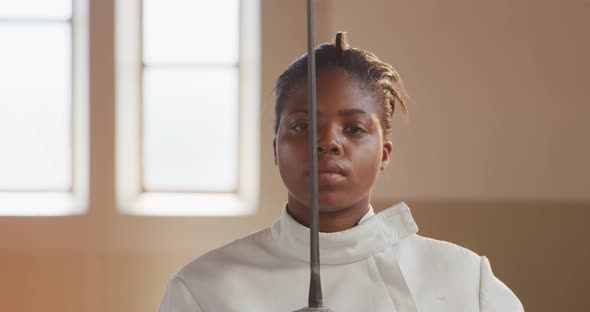 Female fencer athlete during a fencing training in a gym