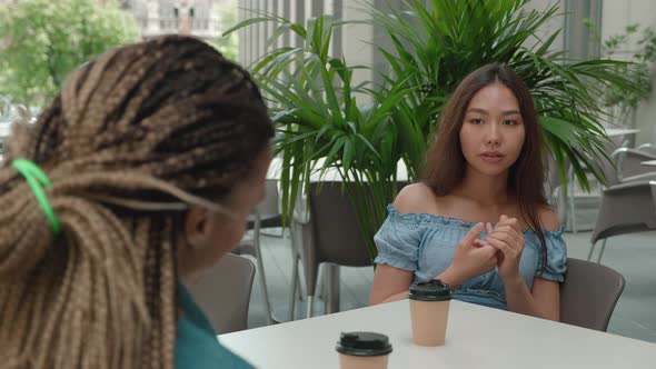 Two Female Friends Talk at a Coffee Break