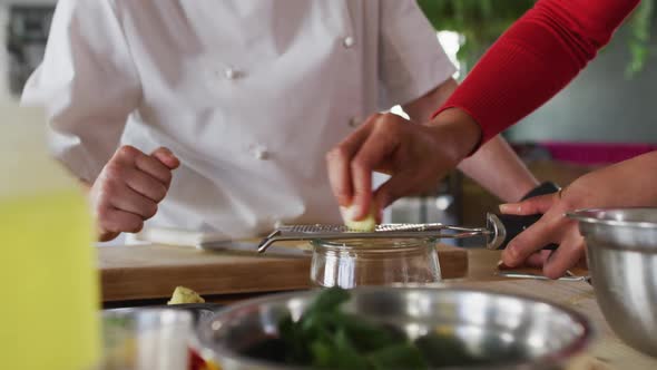 Caucasian female chef teaching diverse group