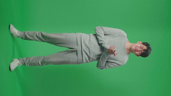 Full Body Of Asian Man Clapping Her Hands In The Green Screen Studio