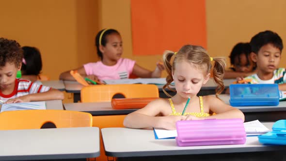 School kids studying in classroom