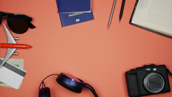 Airplane Model Moving Over Coral Background with Travel Accessories Around the Edges