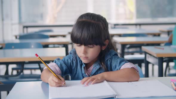 Focused Primary School Pupil Girl Holding Pencil