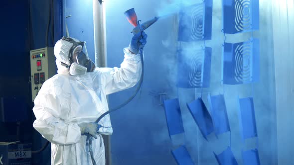 Female Worker Is Air-brushing Metal Pieces