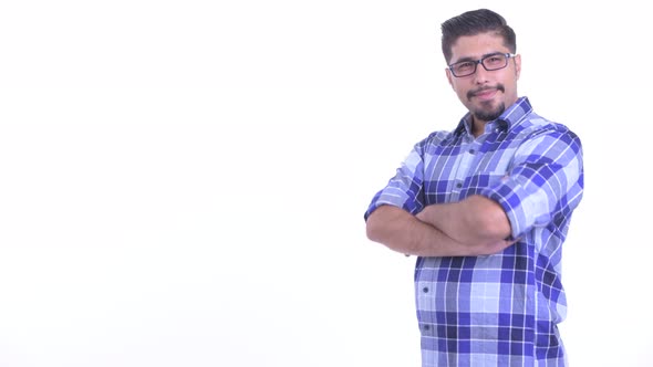 Profile View of Happy Bearded Persian Hipster Man Smiling with Arms Crossed