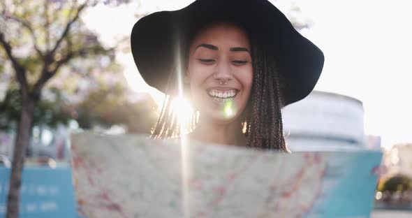 Bohemian mixed race young woman looking on city map - Summer vacation and lifestyle concept