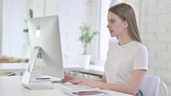 Ambitious Young Woman Celebrating Success in Office 