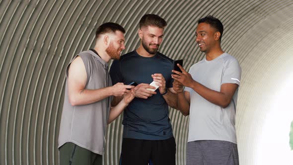 Sporty Men or Friends with Smartphones Outdoors